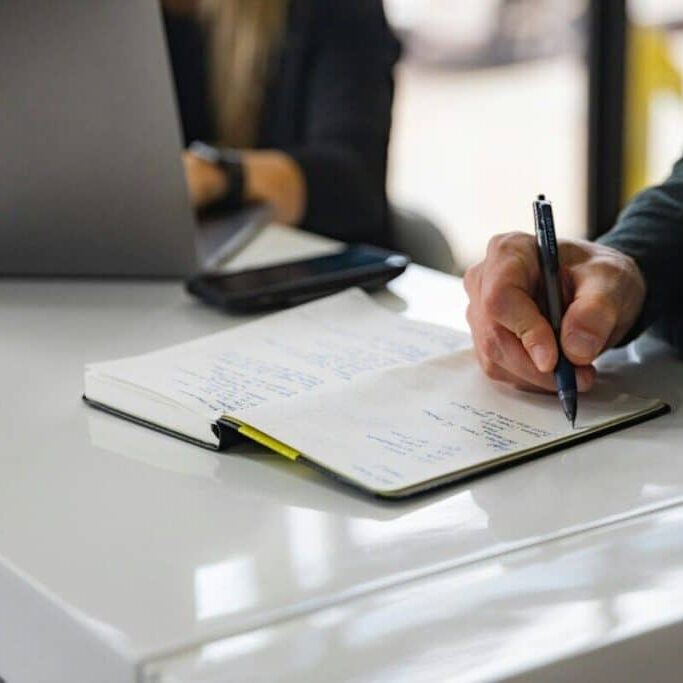 person writing on white paper